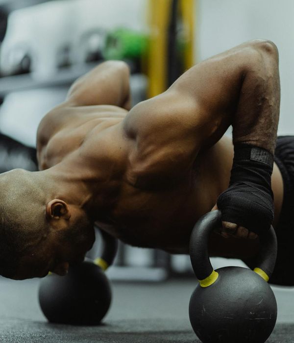 Man holding a kettlebell in a strong, stable stance.