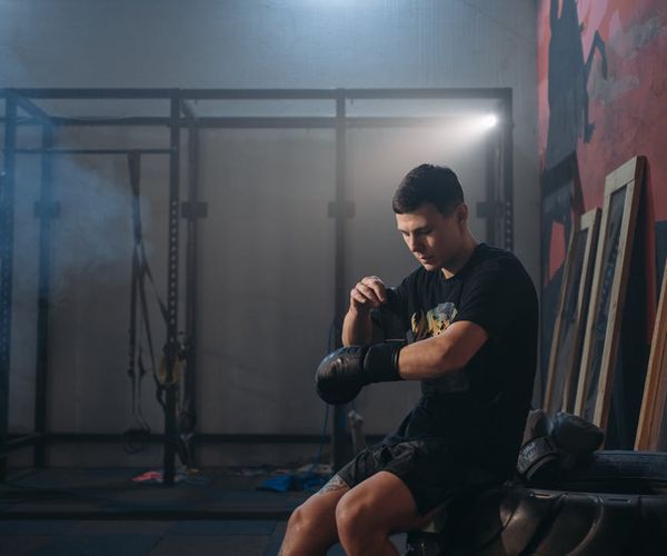 Silhouette of a man stretching with focus and determination.